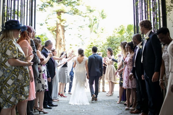 Bride and groom leave wedding ceremony