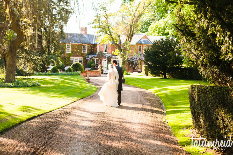 Bride and groom walking down path