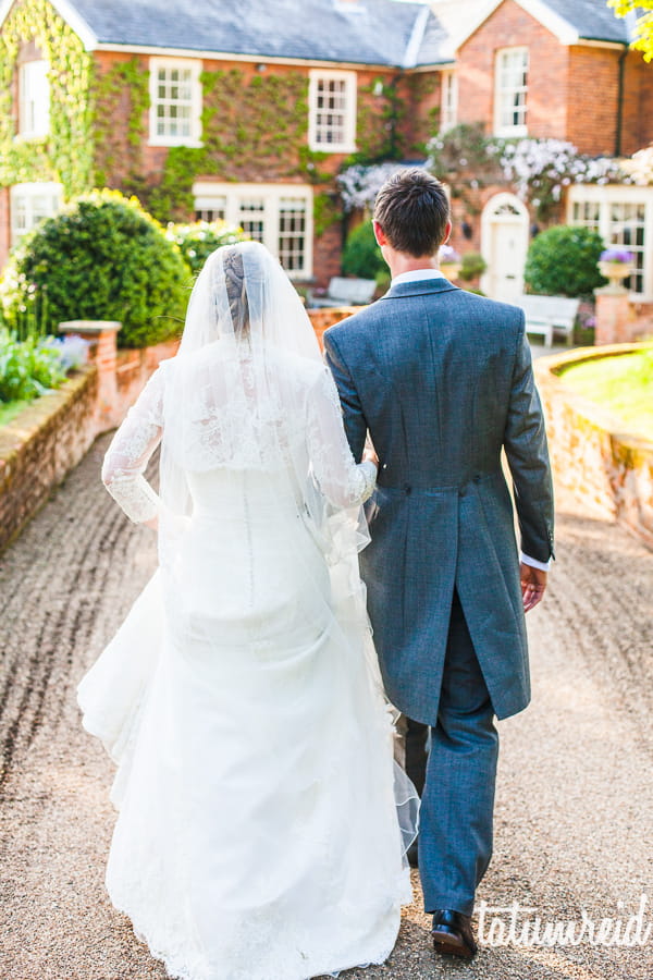 Bride and groom walking down path