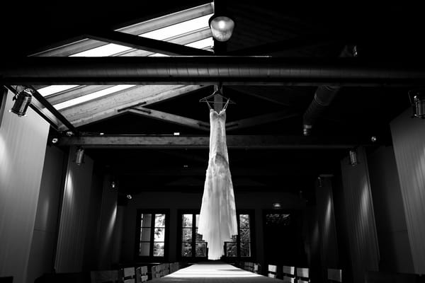 Wedding dress hanging from ceiling