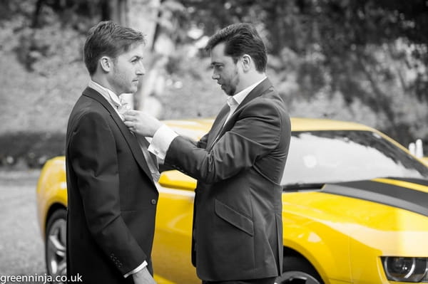 Groom and best man in front of Bumblebee Transformers wedding car