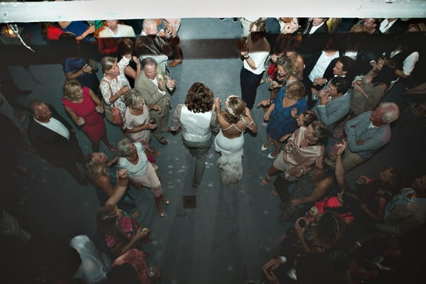 Bride and groom walking into reception party