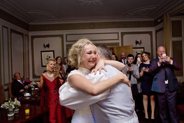 Emotional bride hugging father