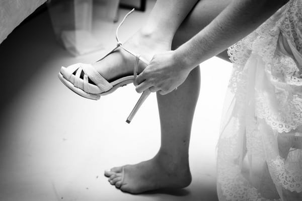 Bride putting shoes on