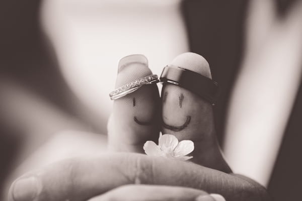 Thumbs with faces and wedding rings on - Picture by Twirly Girl Photography