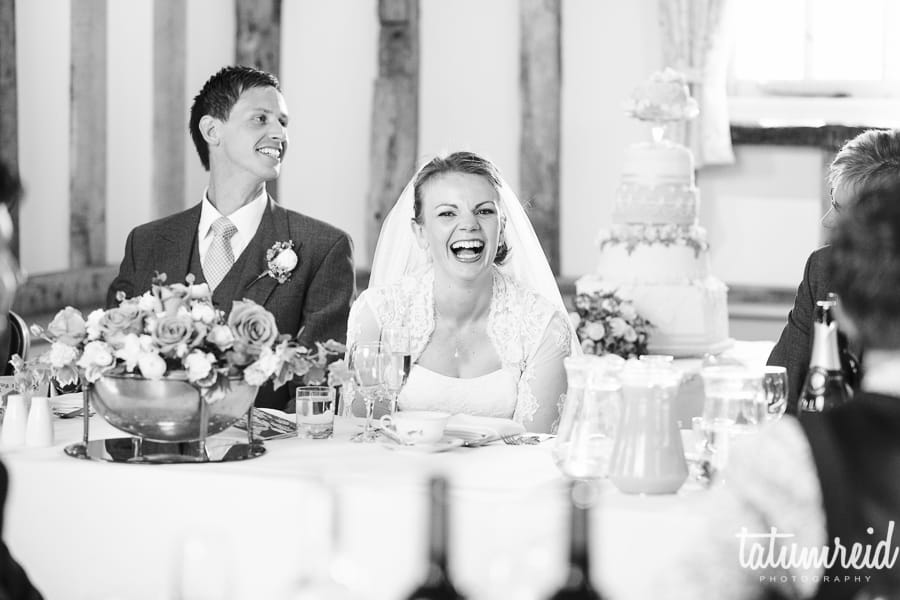 Bride laughing at wedding speech