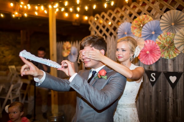 Bride covering groom's eyes