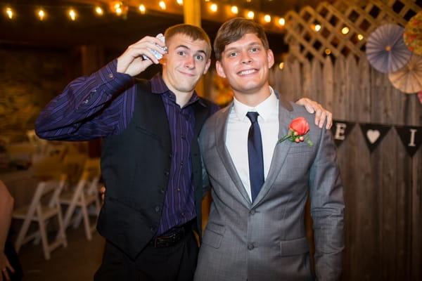 Man who caught garter posing with groom