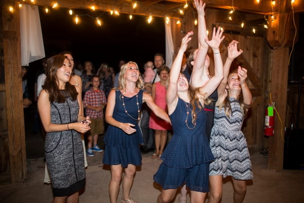 Women trying to catch bouquet