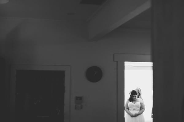 Bride getting ready seen through doorway