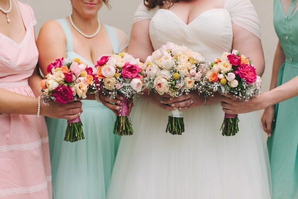 Bride and bridesmaids holding bouquets