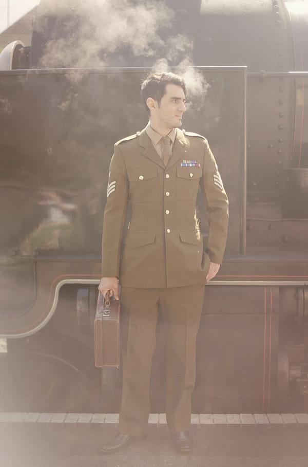 1920's groom in soldiers uniform standing in front of train