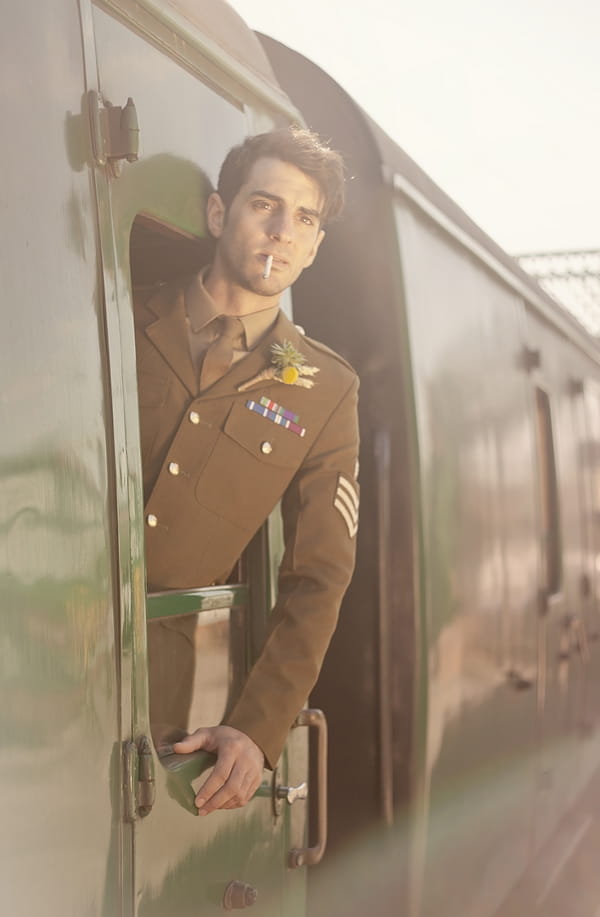 1920's groom in soldiers uniform leaning out of train