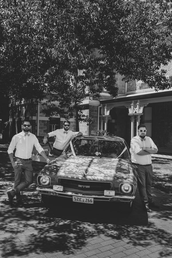 Groomsmen by wedding car