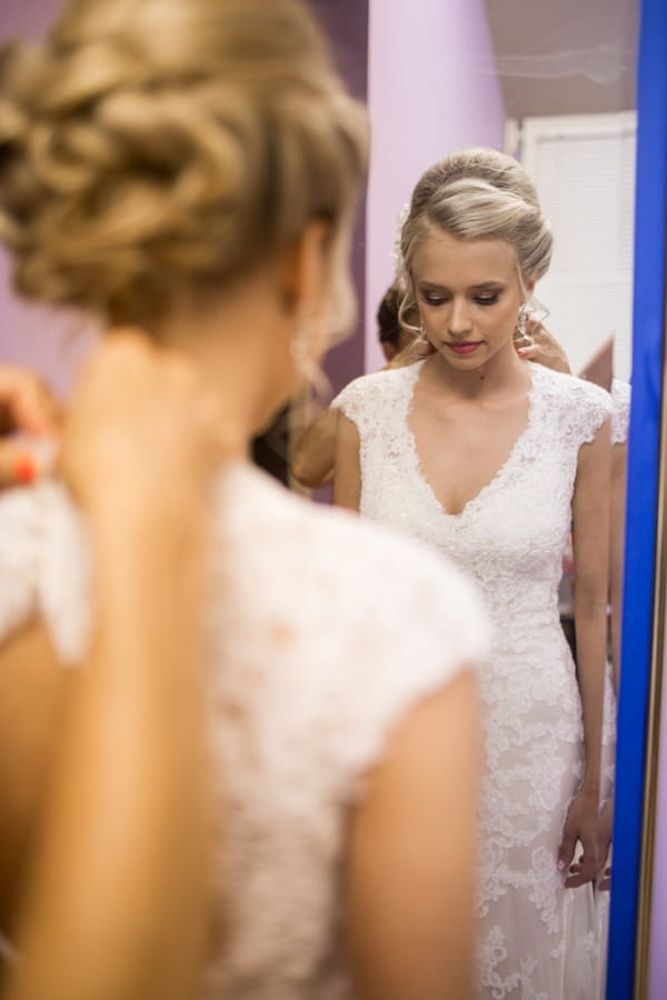 Bride standing in front of mirror