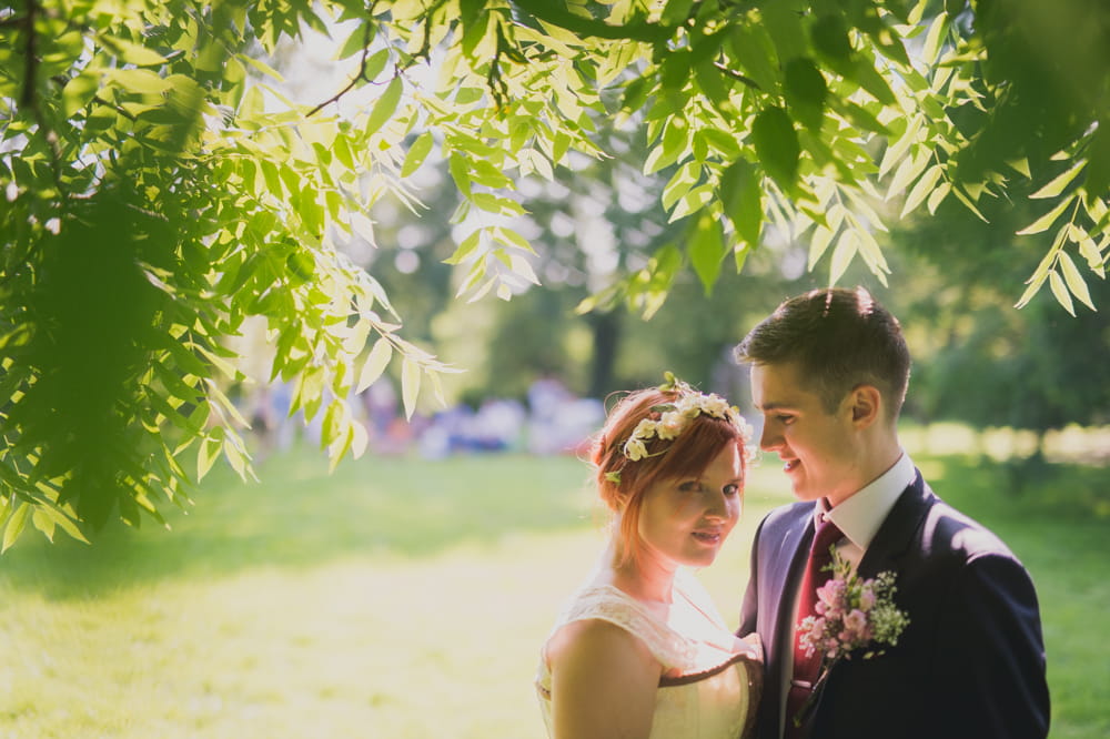 Bride and groom under tree