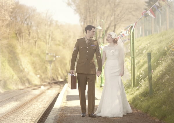 1920's bride and groom walking next to train track