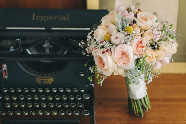 Old typewriter and wedding bouquet