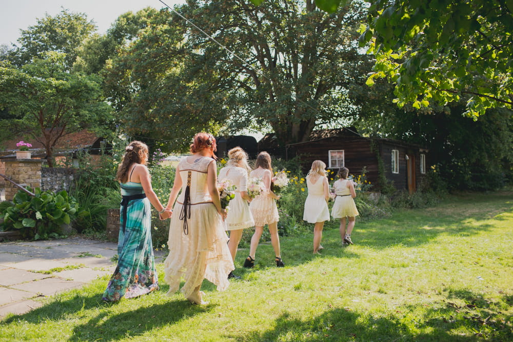 Bride and bridesmaids walking to ceremony