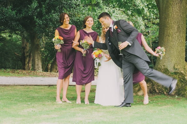 Groom getting in way of wedding picture