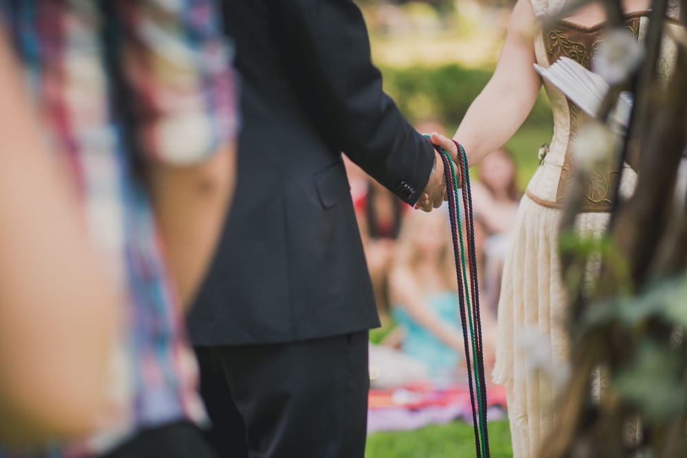 Bride and groom's hands tied