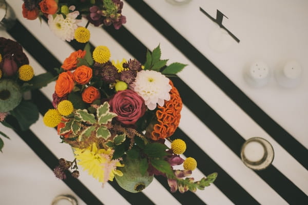 Flowers on black and white striped table cloth