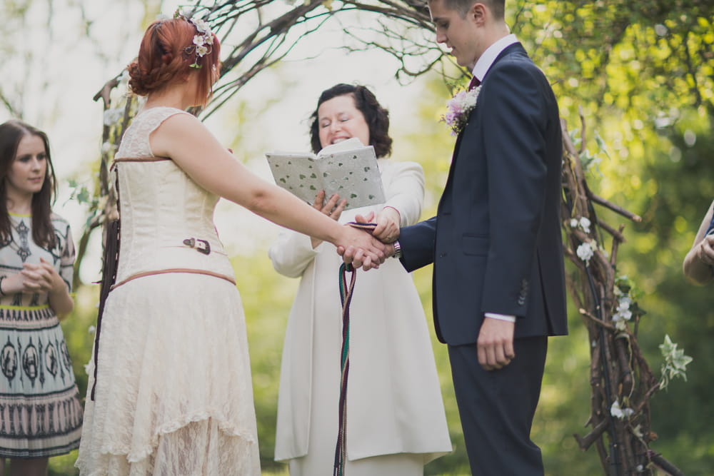 Bride and groom's hands tied