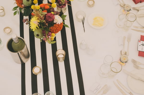 Flowers on black and white striped table cloth