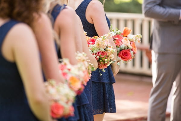 Row of bridesmaids holding bouquets