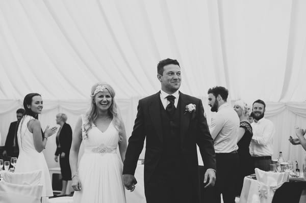 Bride and groom entering wedding reception