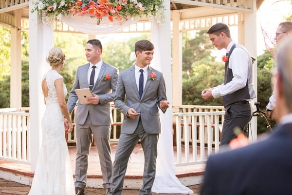 Best man giving groom rings