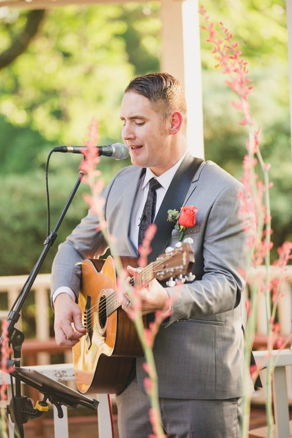 Man playing guitar at wedding ceremony