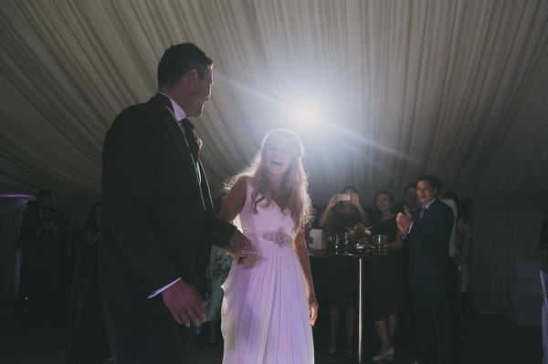 Bride and groom walking to dance floor