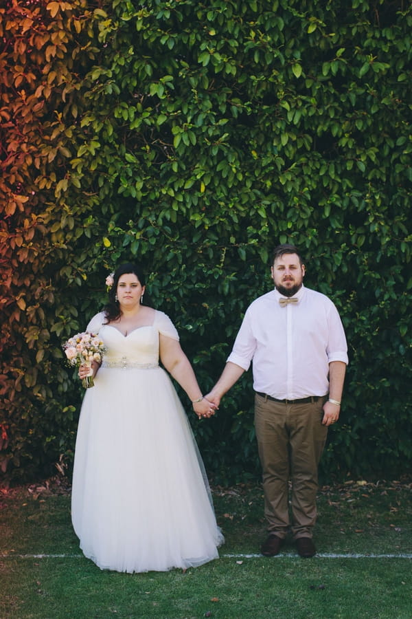 Bride and groom holding hands