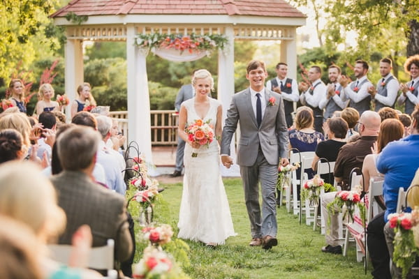 Bride and groom walk back down aisle