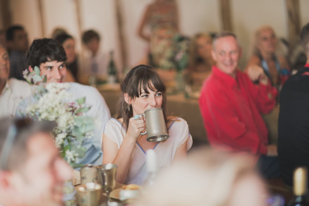 Wedding guest drinking from silver goblet