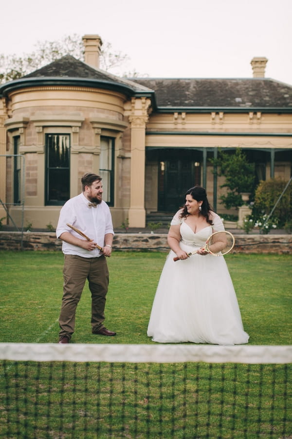 Bride and groom with tennis rackets