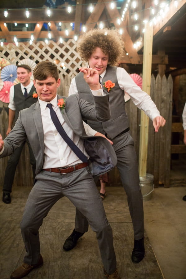 Groom and groomsman dancing