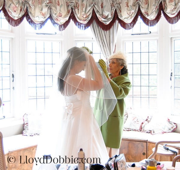 Bridal Preparation Photograph of Mother Helping Bride with Veil