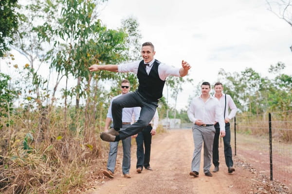 Groom jumping in air