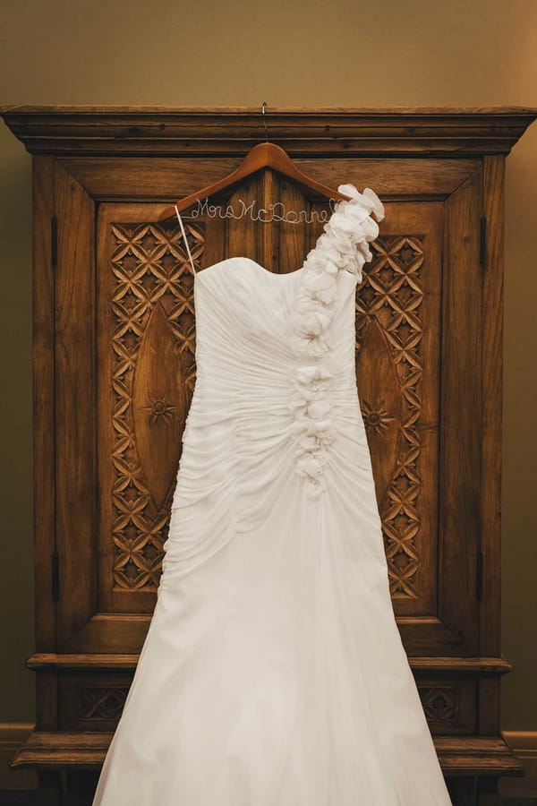 Wedding dress hanging on wardrobe