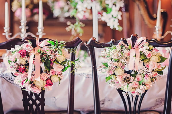 Flowers on back of wedding chairs