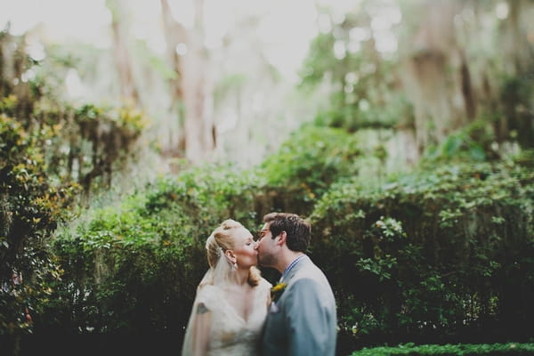 Bride and groom kissing at Magnolia Plantation and Gardens