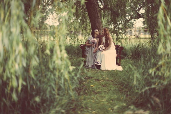 Brides sitting under tree