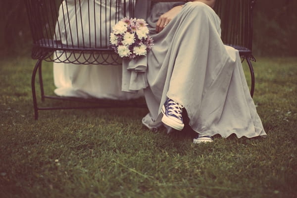 Bride's legs and Converse trainers