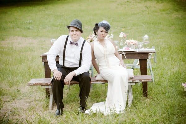 Vintage bride and groom sitting on bench