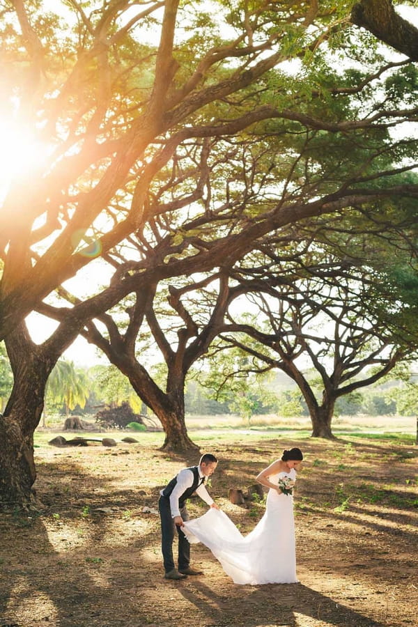 Bride and groom under tree