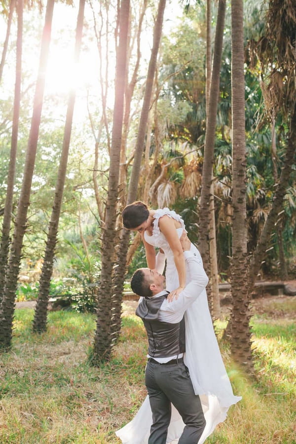 Groom lifting up bride