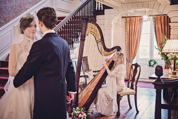 Bride and groom with harpist