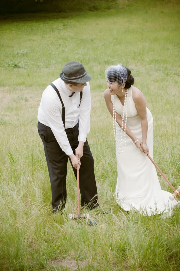 Vintage bride and groom playing croquet